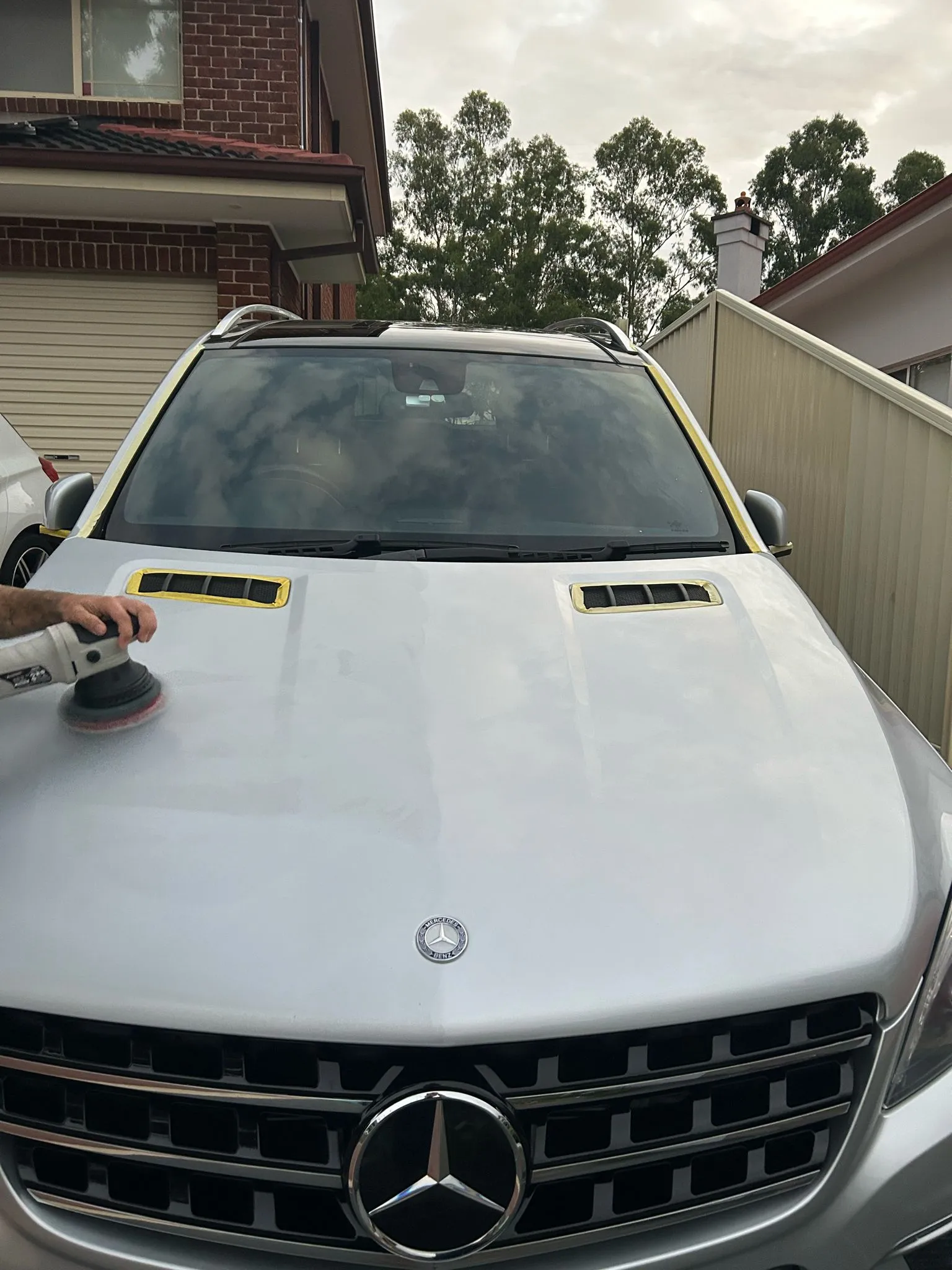 ML 63 AMG hood being machine polished — paint correction